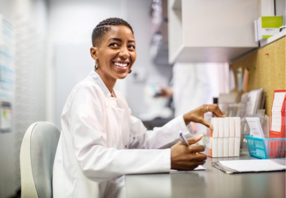 Female African American pharmacist filling prescriptions